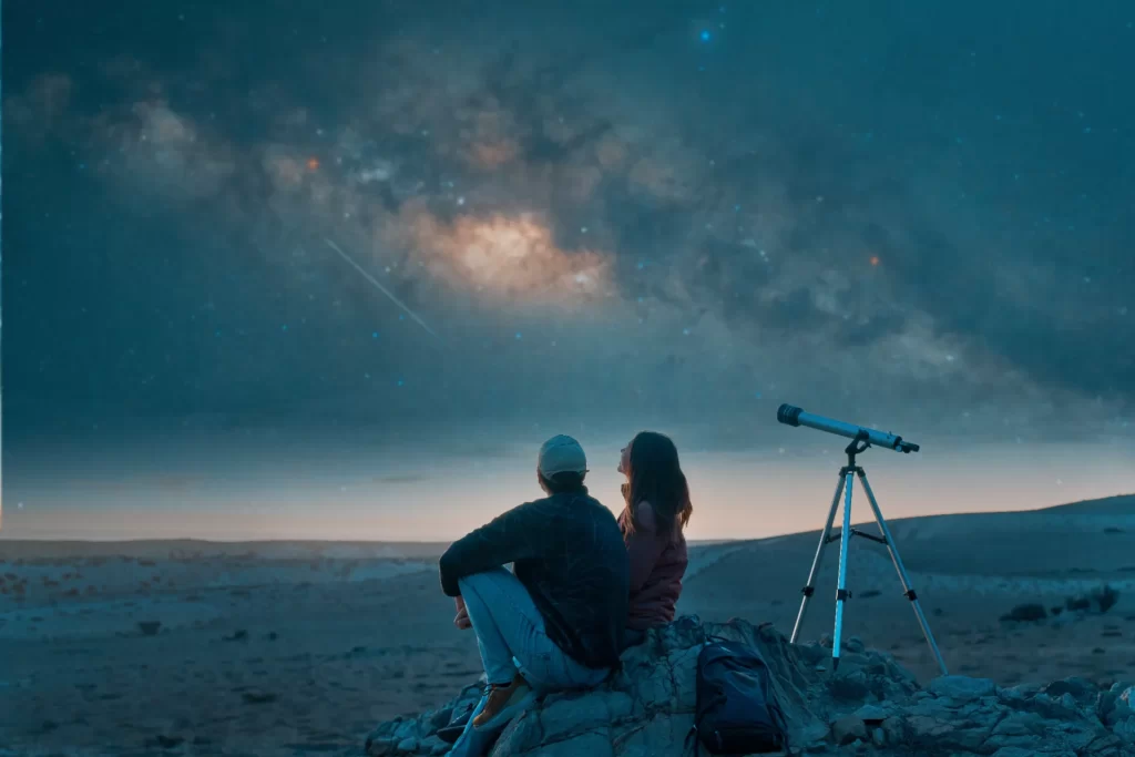 couple sitting on top of the desert a remote local utc